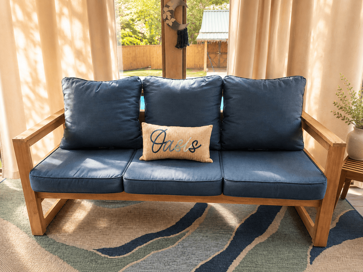 Front view of a handcrafted solid wood sofa with blue cushions and clean modern lines.