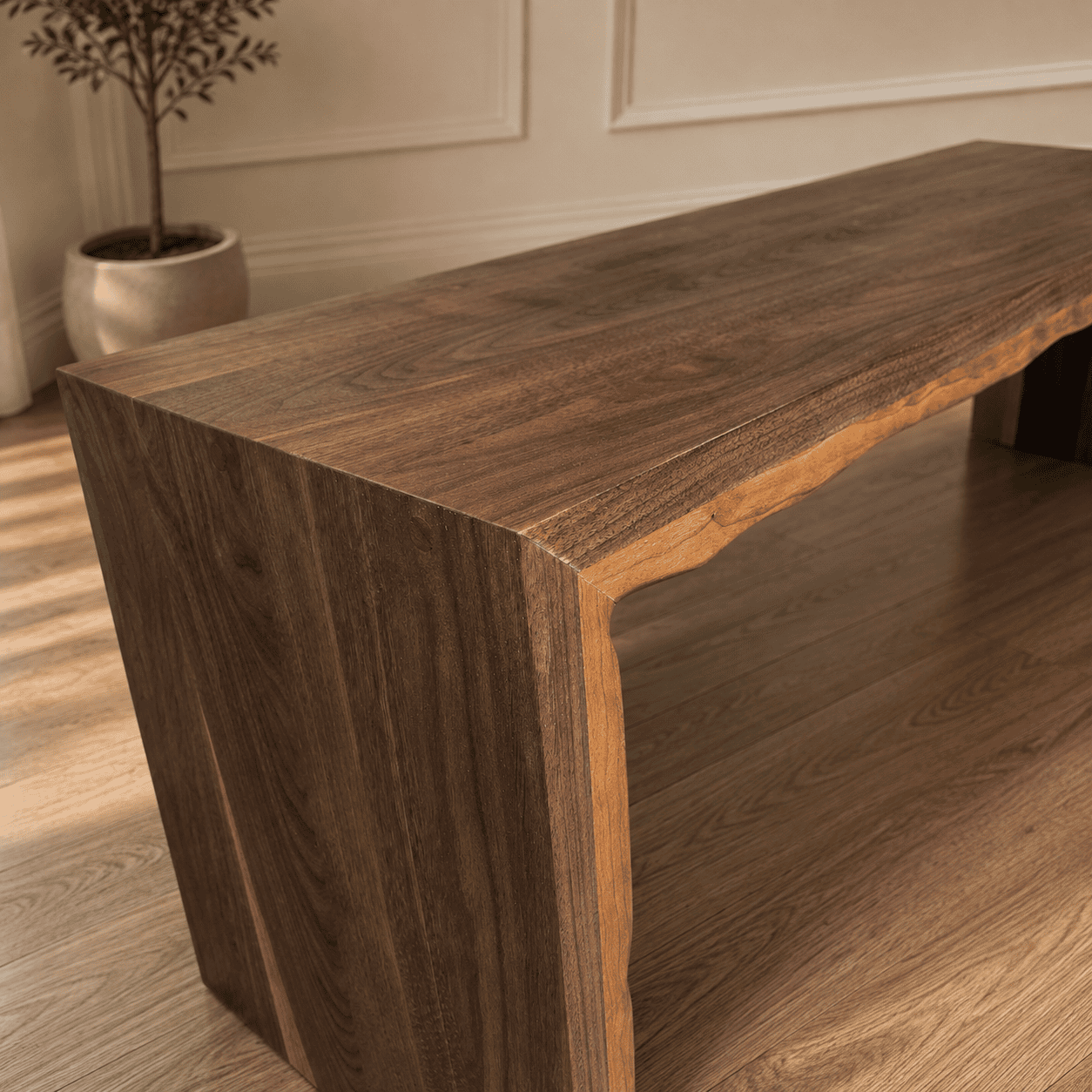 Close-up of handcrafted live edge walnut waterfall bench showing natural wood grain and continuous waterfall joinery.