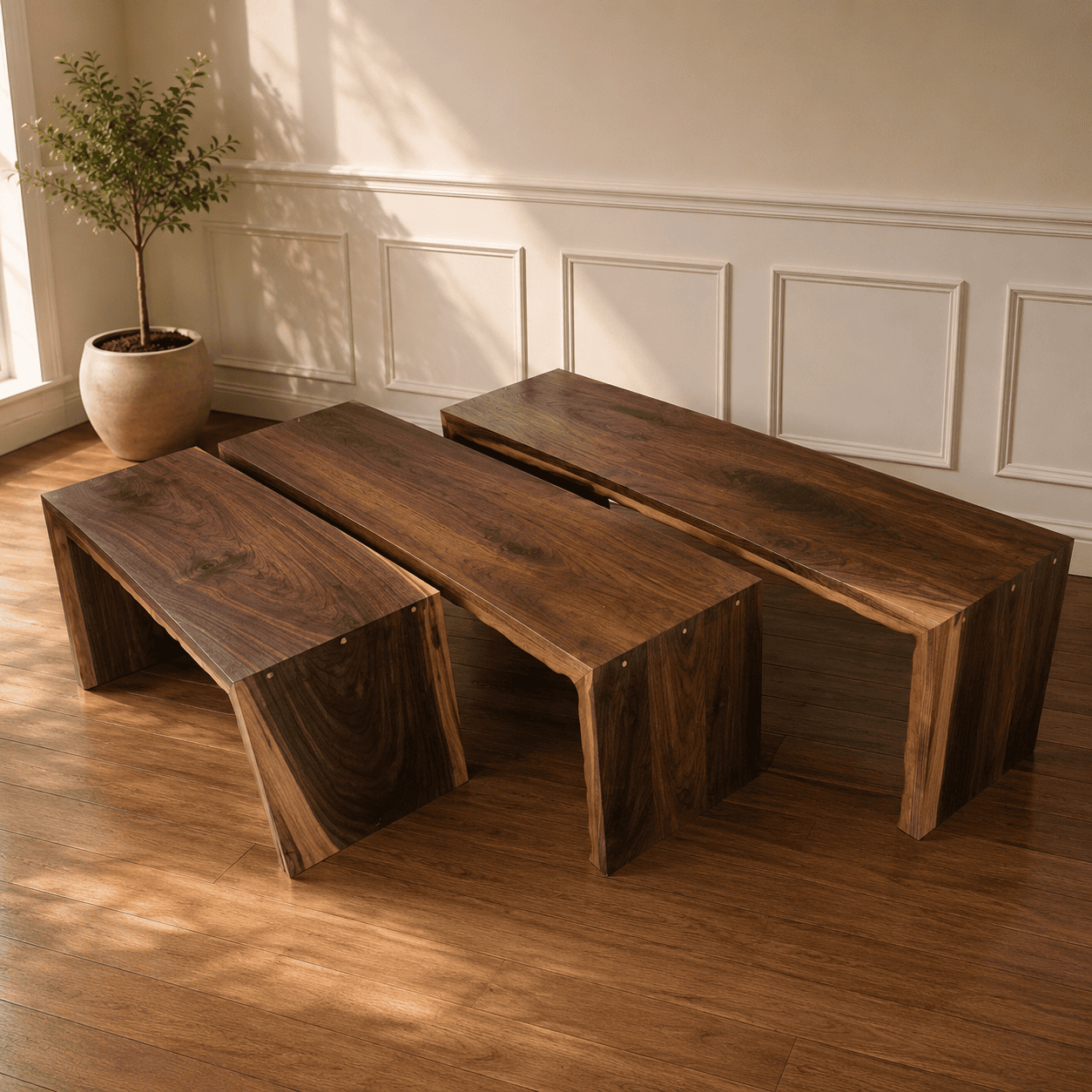 Close-up of three handcrafted walnut waterfall benches highlighting natural live edges, grain variation, and waterfall legs.