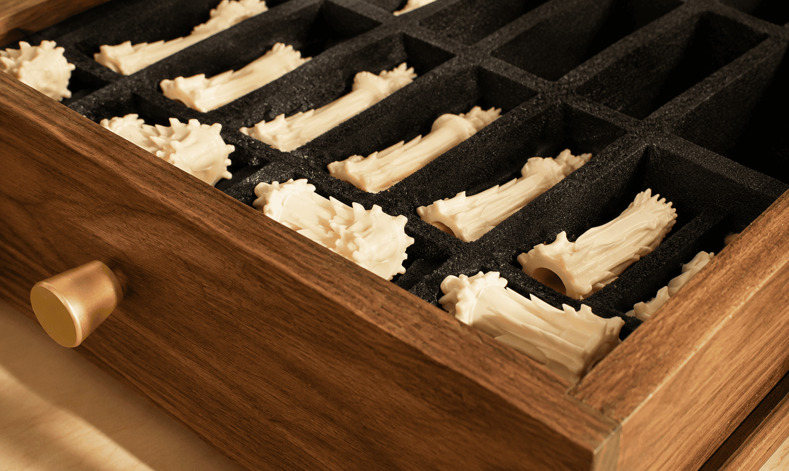 Custom foam storage insert with white sculptural chess pieces