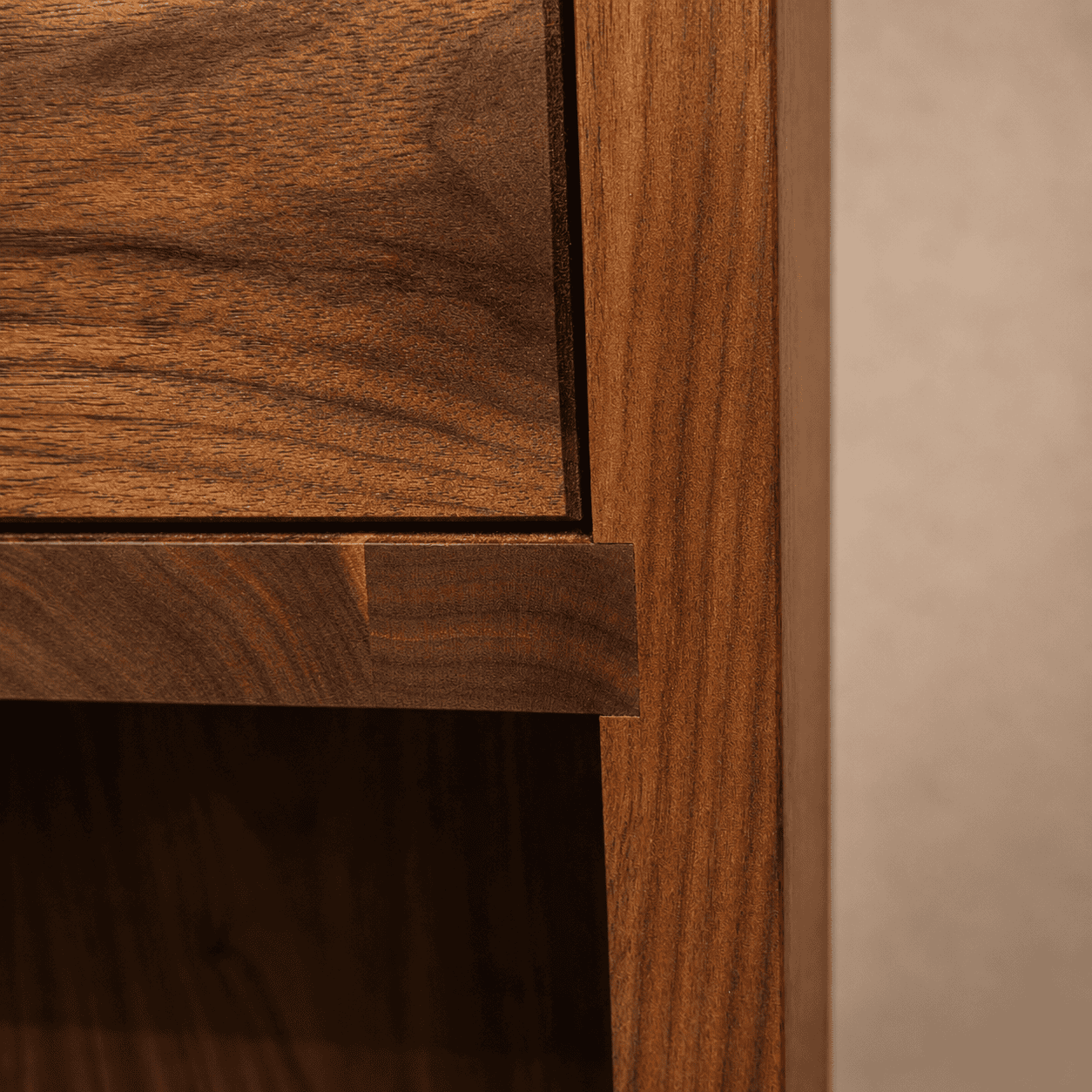 Close-up of walnut nightstand joinery and solid wood drawer construction