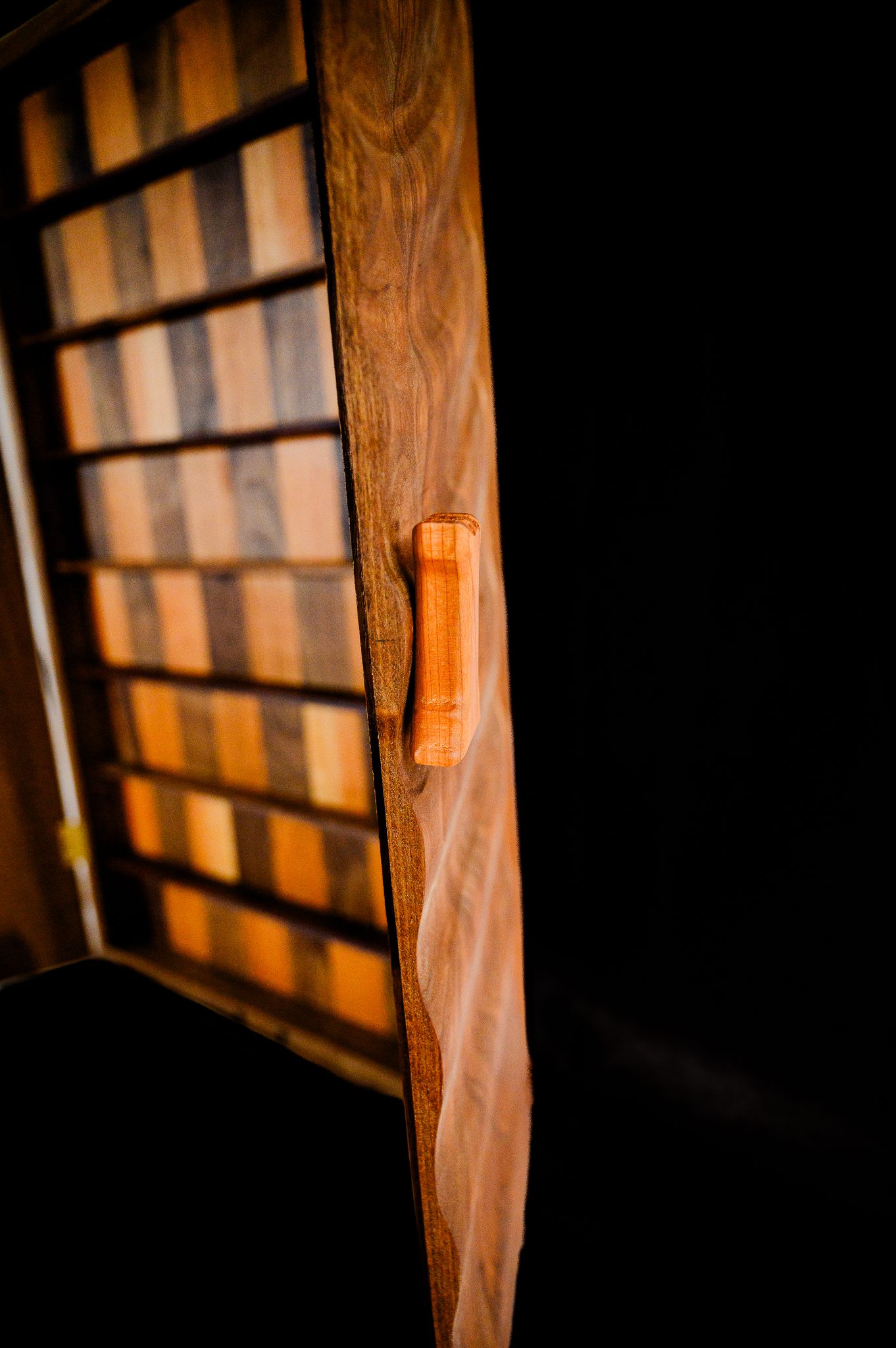 Side view of open walnut chessboard showing handcrafted construction