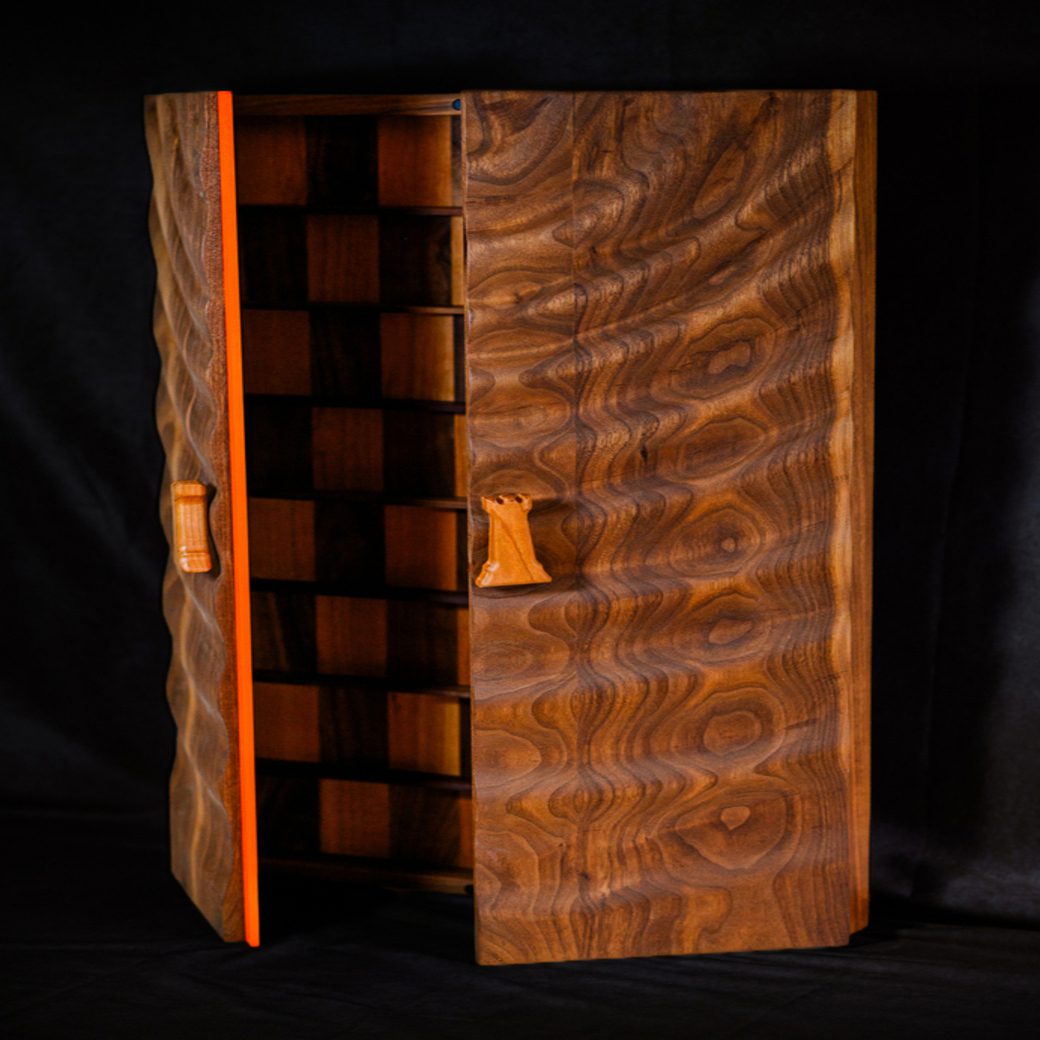 Folding walnut chessboard partially open showing board and exterior grain