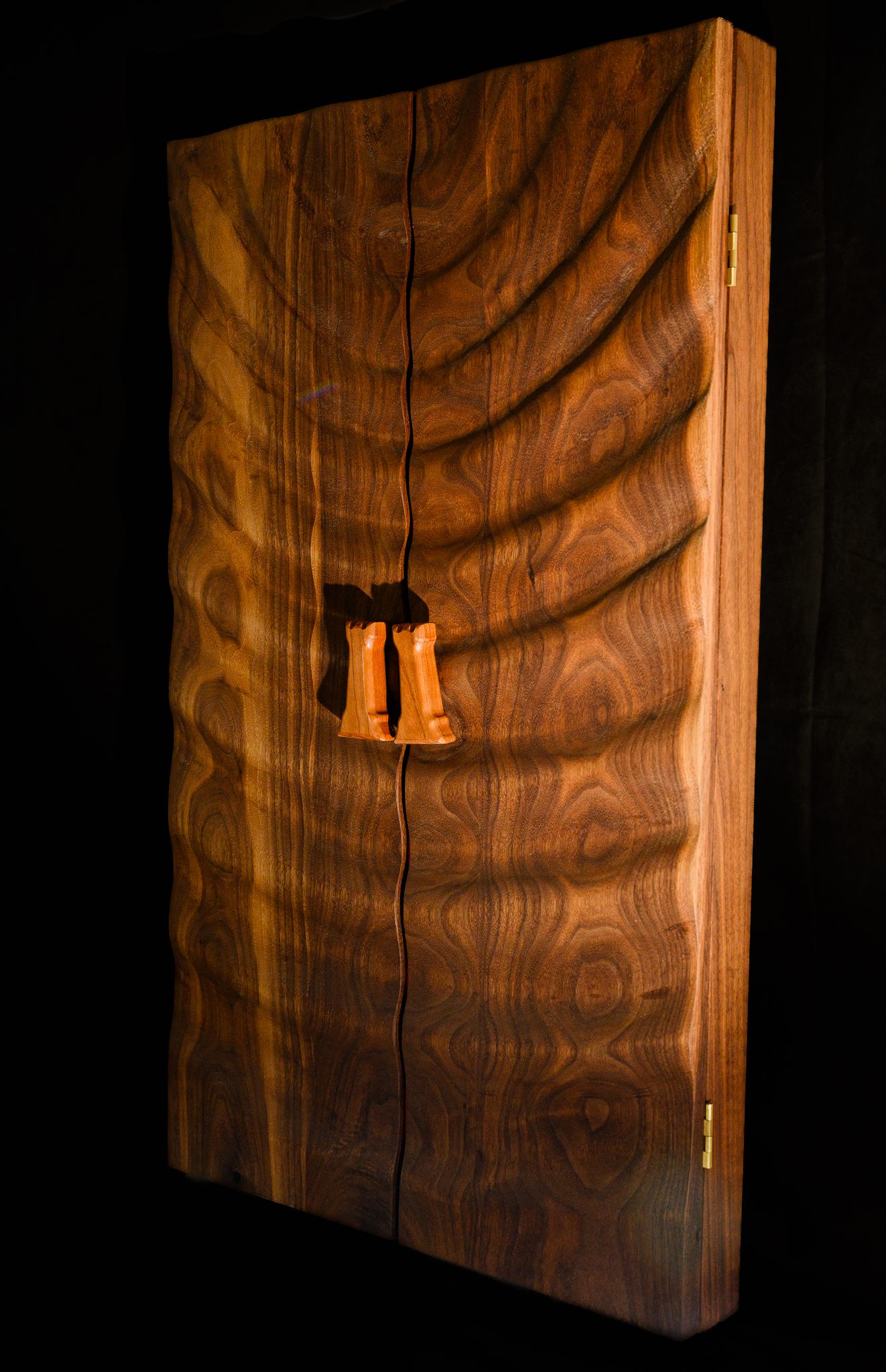 Closed folding walnut chessboard showing natural wood grain and handles