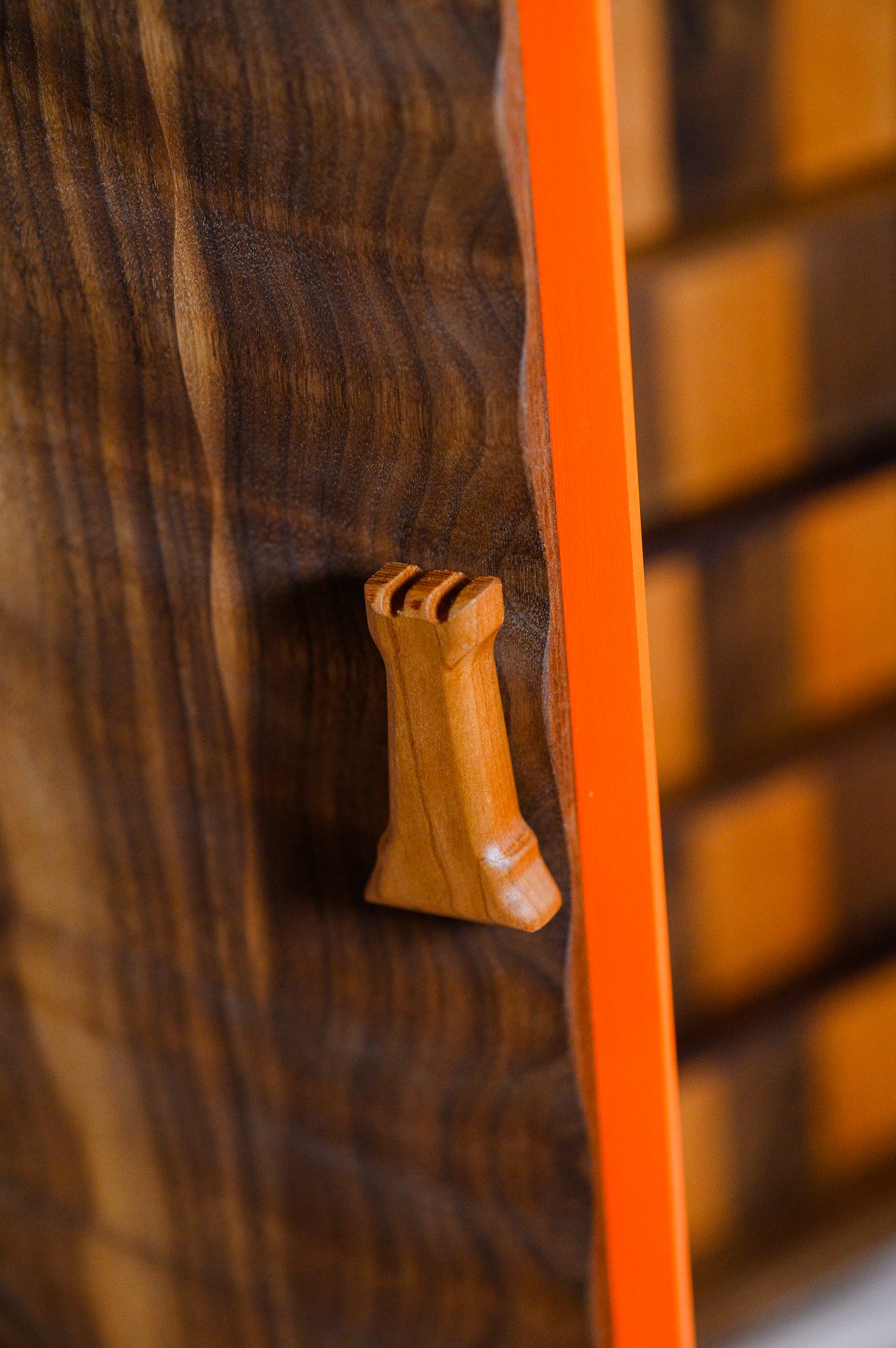 Close-up of handcrafted walnut chessboard edge and wood craftsmanship